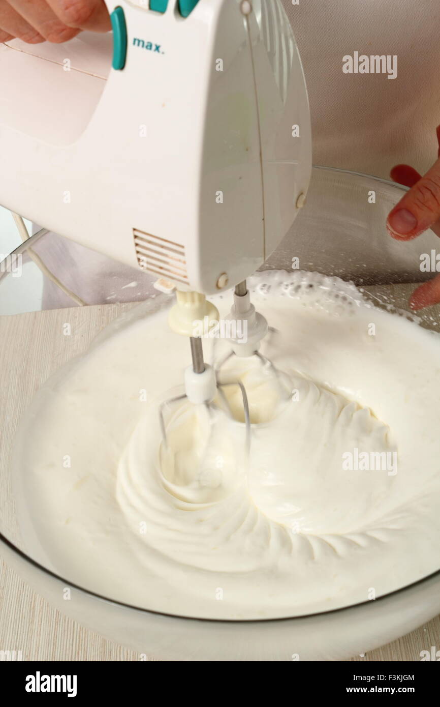 Whisking egg whites and granulated sugar. Making Chocolate Hazelnut
