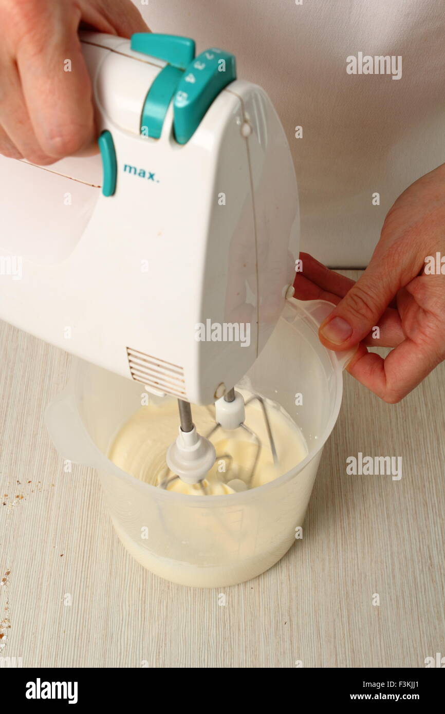 Making ganache. Whipping cream. Making Chocolate Hazelnut Meringue Cake