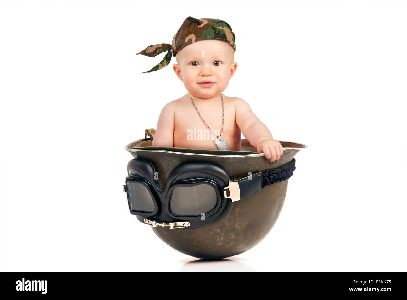 Cute baby girl inside an old military helmet Stock Photo