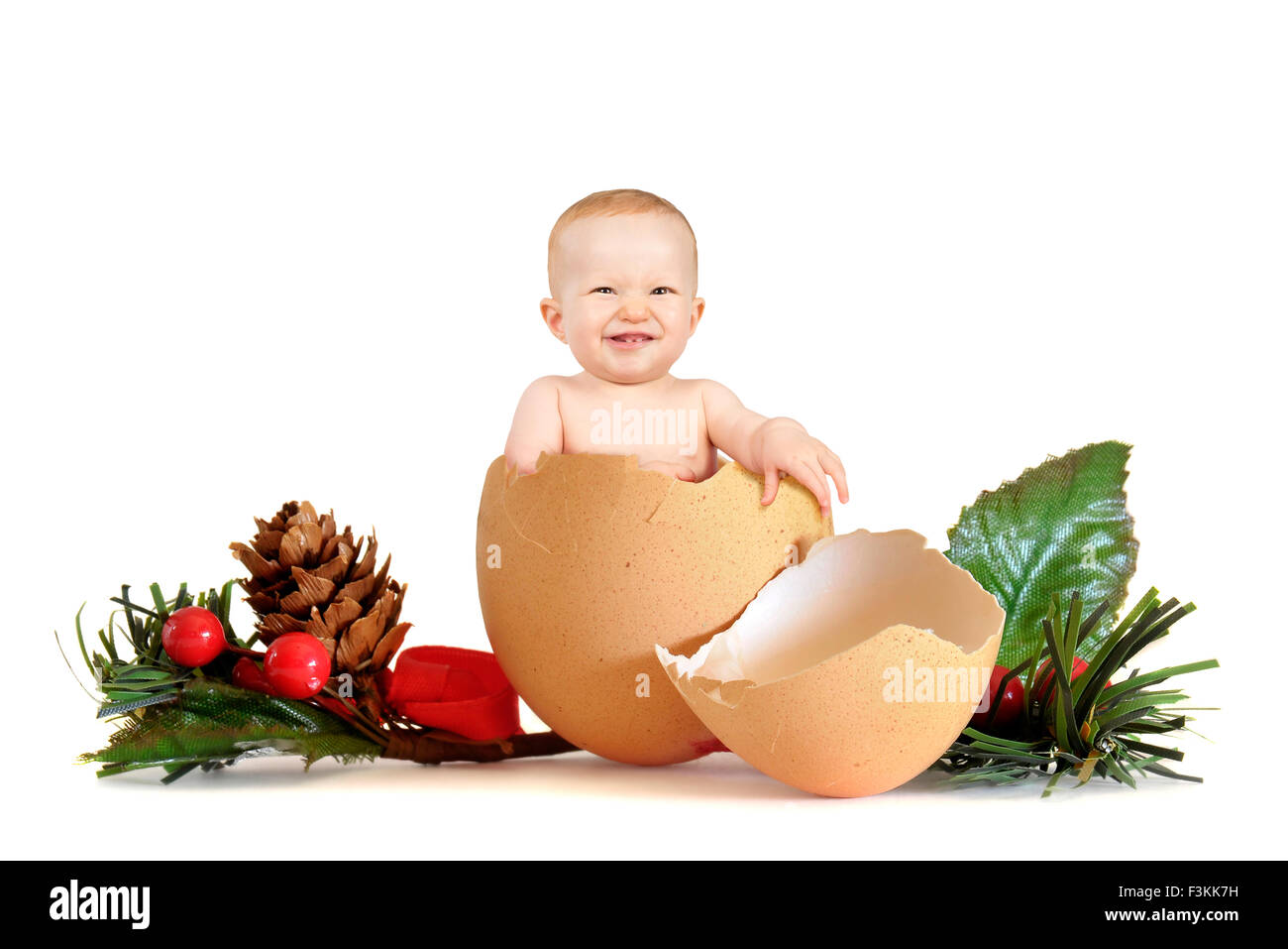 Baby Girl Inside An Egg With Christmas Decoration Isolated In