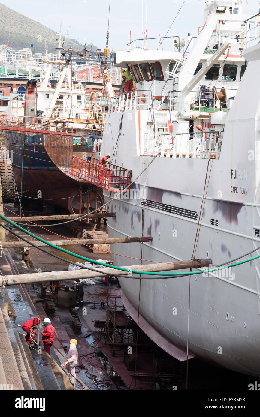 Men working on giant ships in the harbor,  Victoria & Albert V&A Waterfront, Cape Town, South Africa Stock Photo