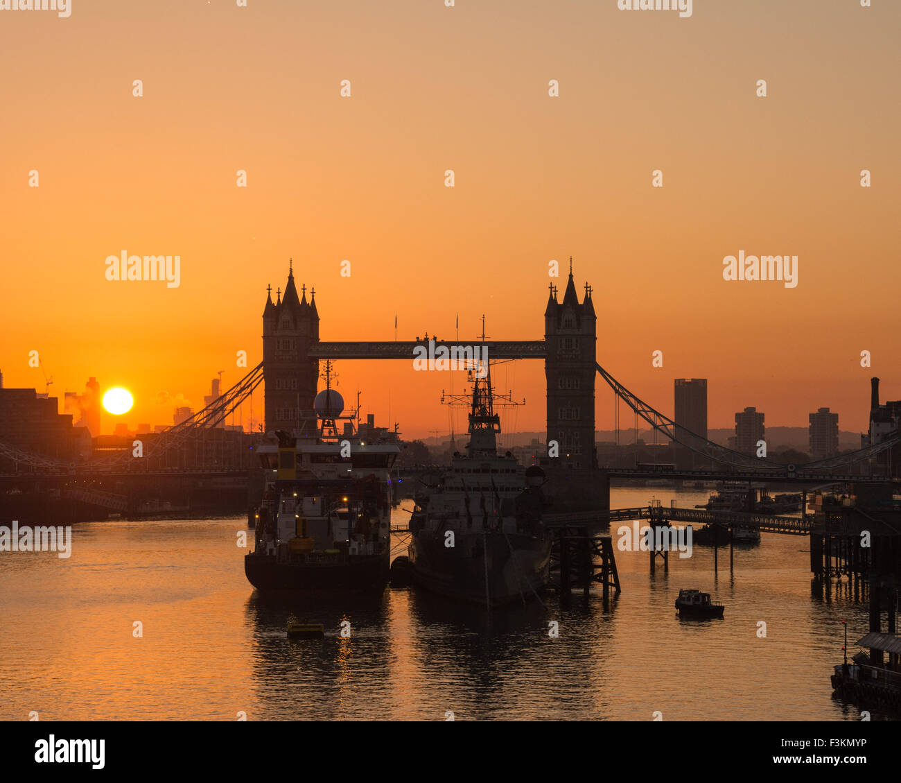 Tower Bridge and museum battleship HMS Belfast are silhouetted against a beautiful sunrise in London. Credit:  Patricia Phillips/Alamy Live News Stock Photo