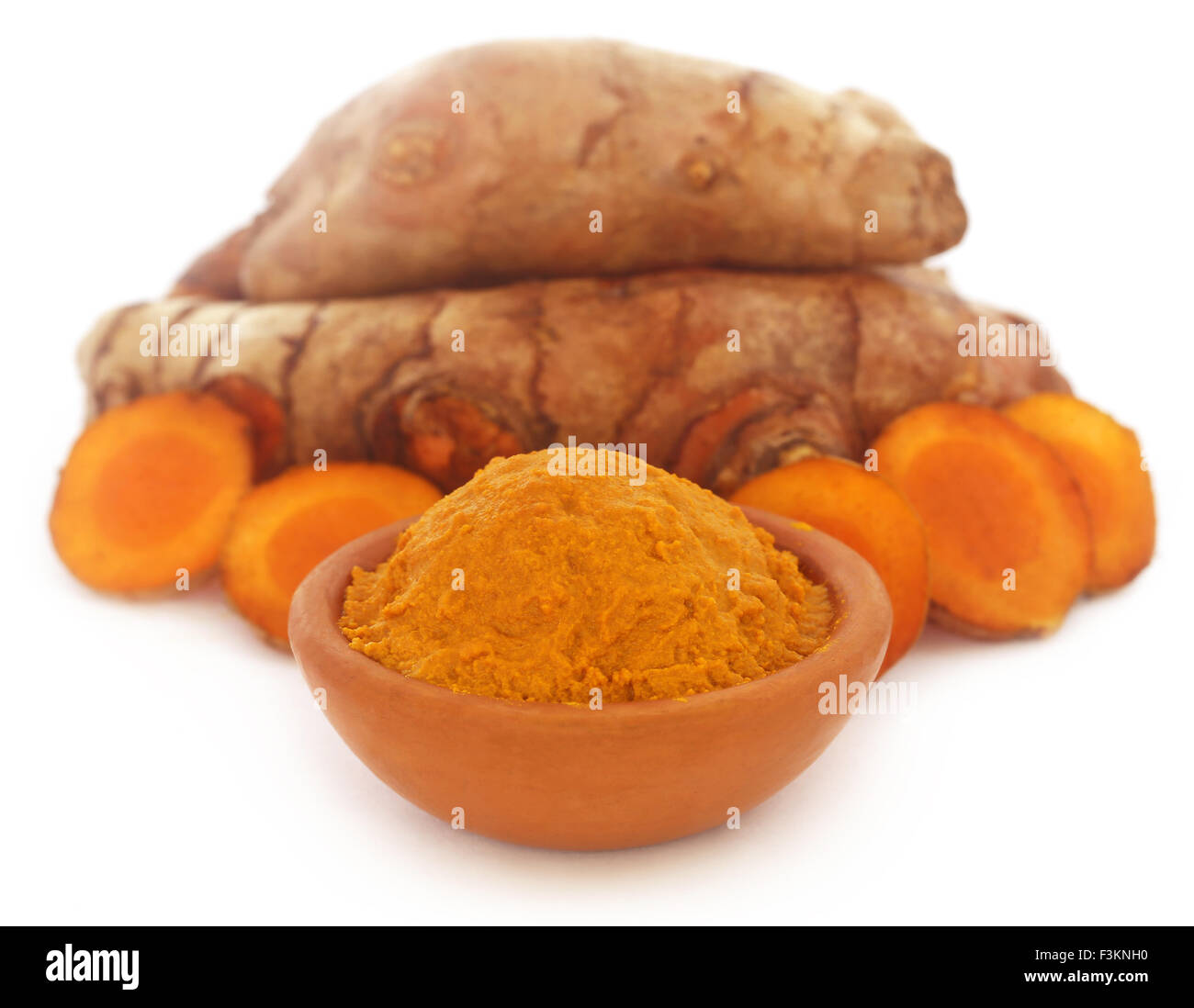 Raw and mashed turmeric over white background Stock Photo - Alamy