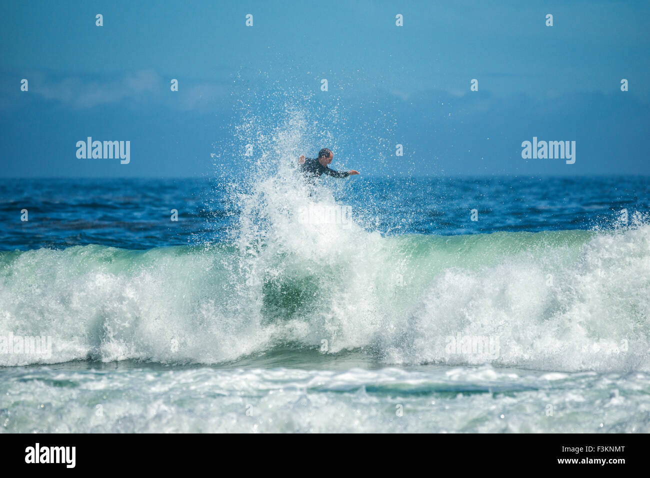 Male surfer rides the top of a wave in the Atlantic Ocean, Llandudno ...