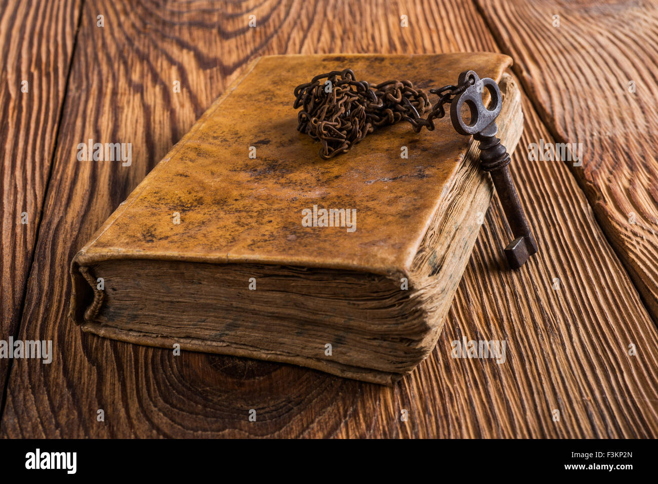 Old key with chain on an book Stock Photo