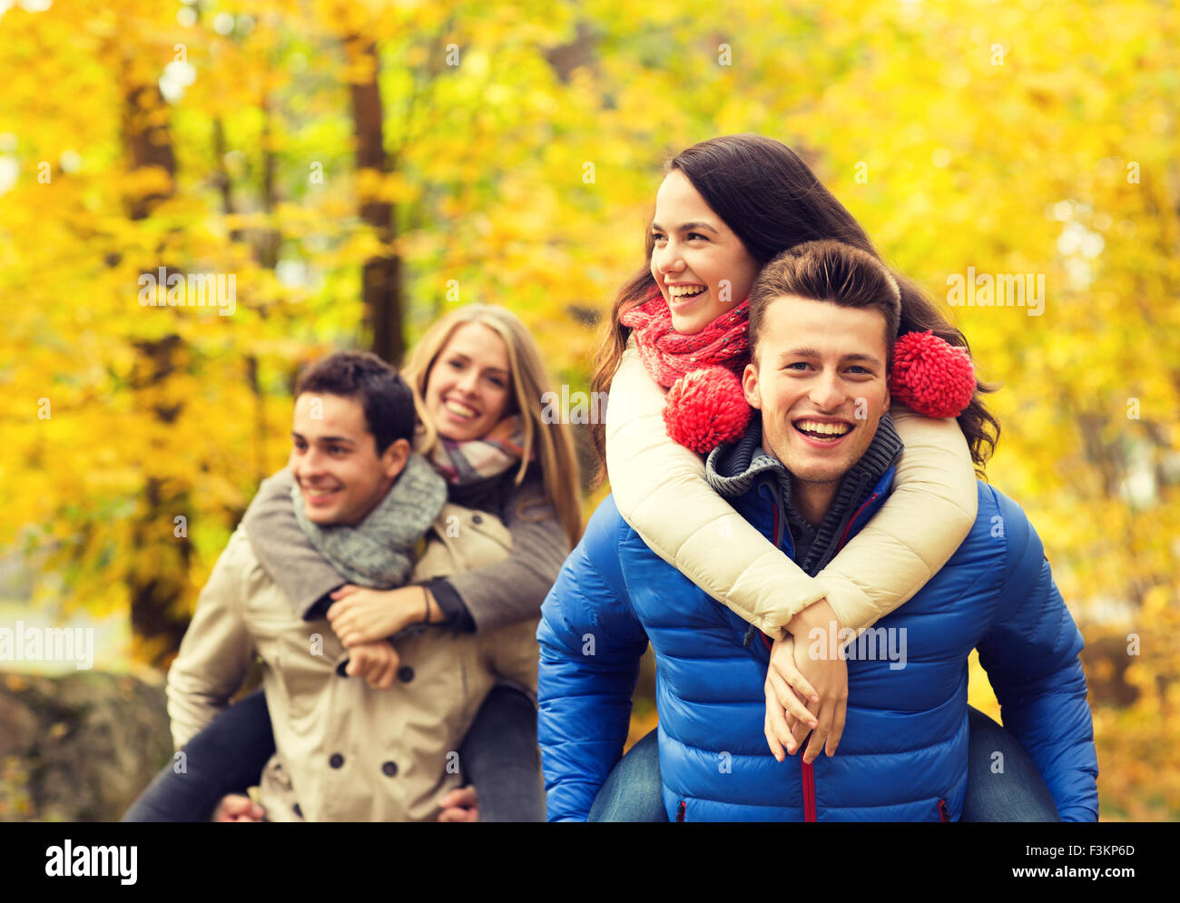 smiling friends having fun in autumn park Stock Photo - Alamy