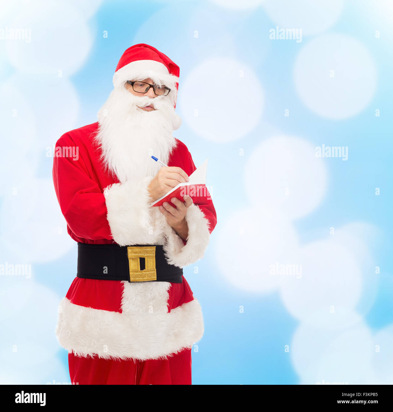 man in costume of santa claus with notepad Stock Photo - Alamy image.