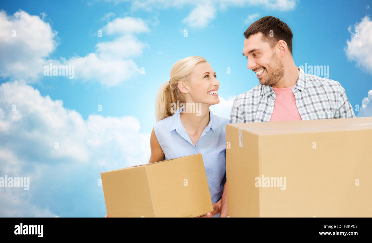 couple with cardboard boxes moving to new home Stock Photo - Alamy