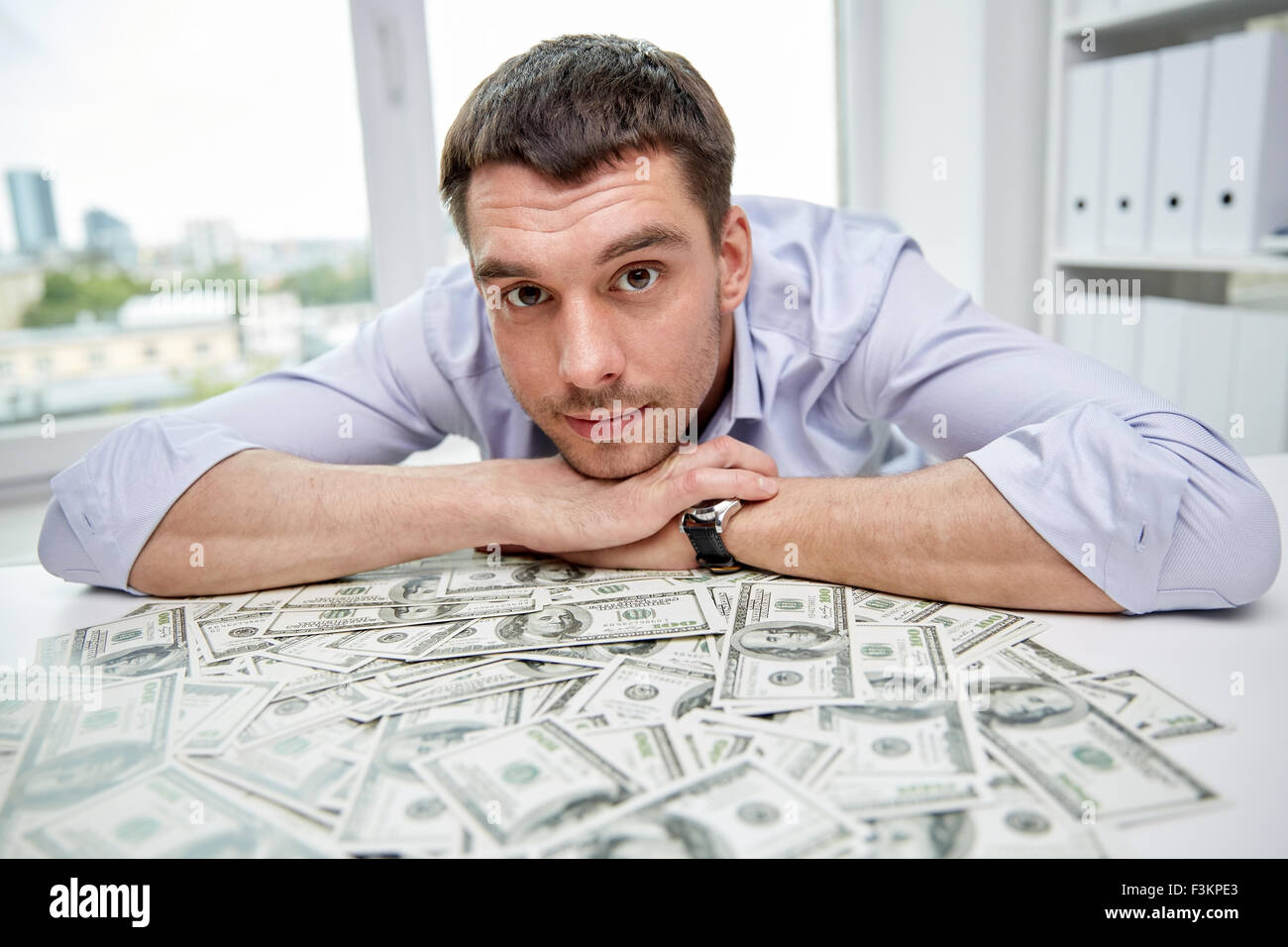 happy businessman with heap of money in office Stock Photo - Alamy