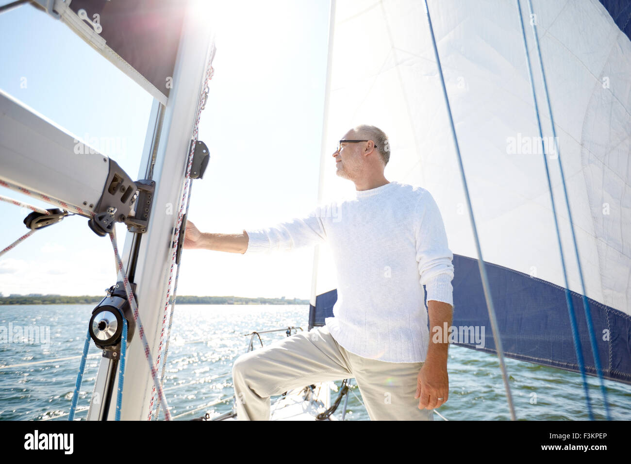 senior man on sail boat or yacht sailing in sea Stock Photo - Alamy