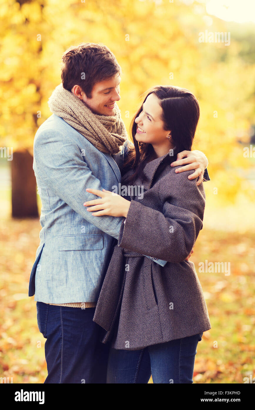 smiling couple hugging in autumn park Stock Photo - Alamy