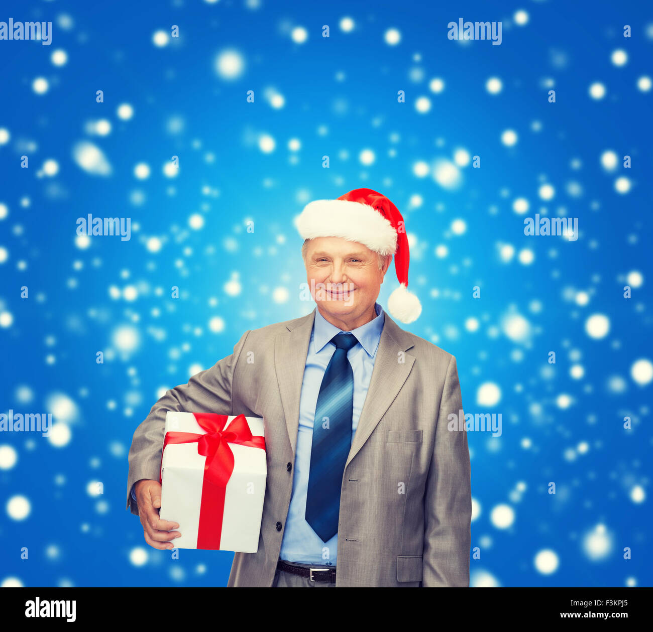 smiling man in suit and santa helper hat with gift Stock Photo - Alamy