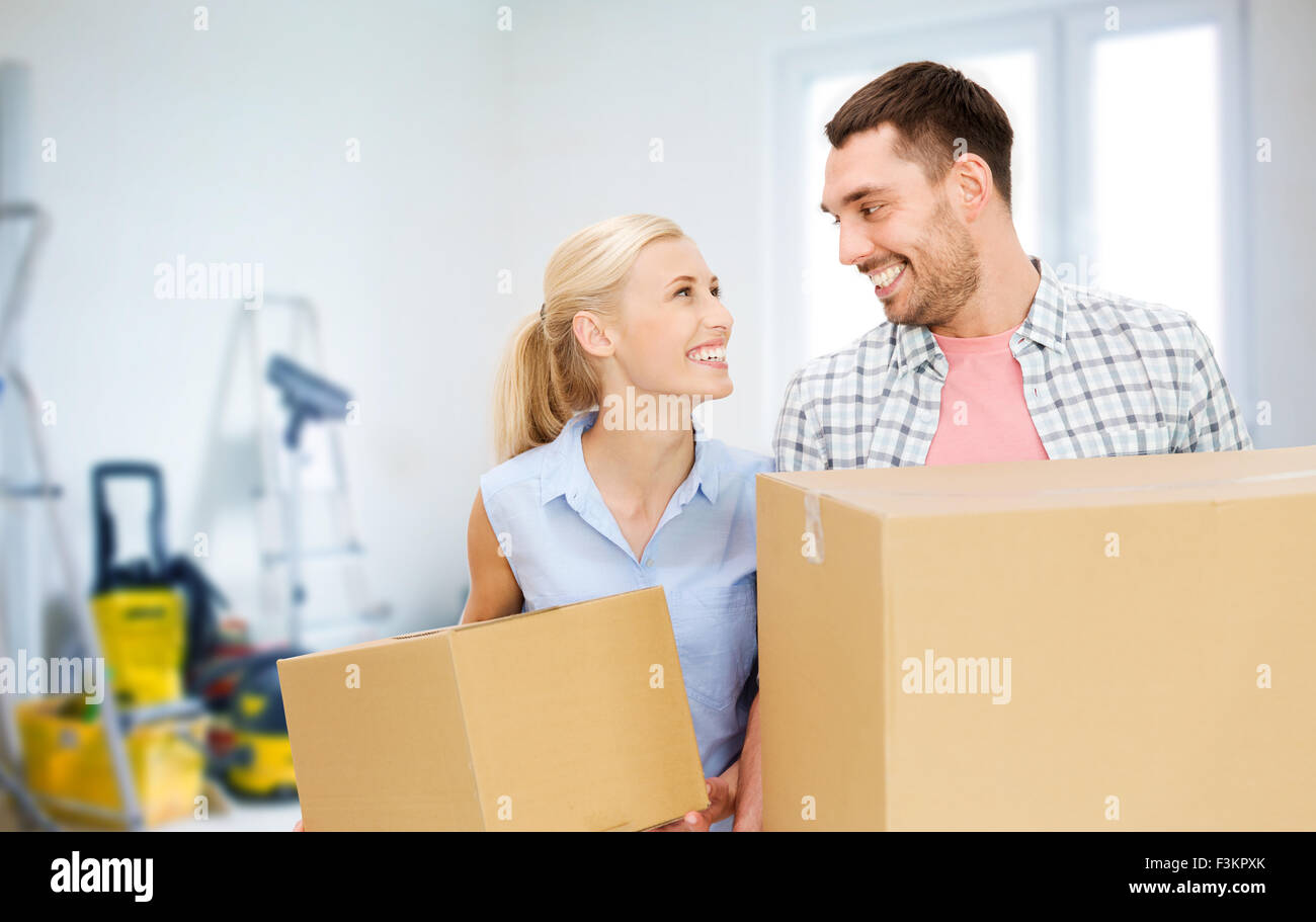 couple with cardboard boxes moving to new home Stock Photo - Alamy