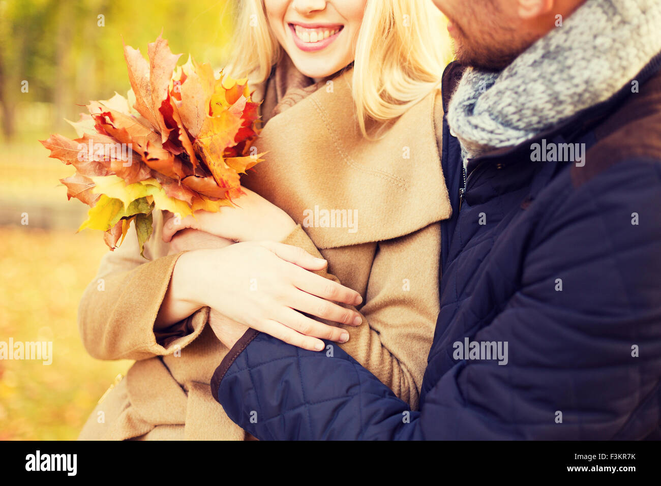 close up of smiling couple hugging in autumn park Stock Photo - Alamy