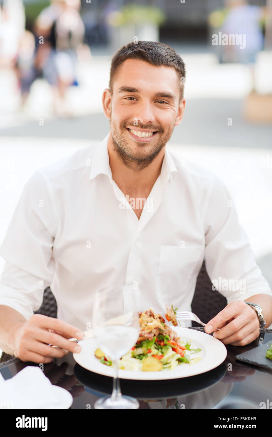 happy man eating salad for dinner at restaurant Stock Photo Alamy