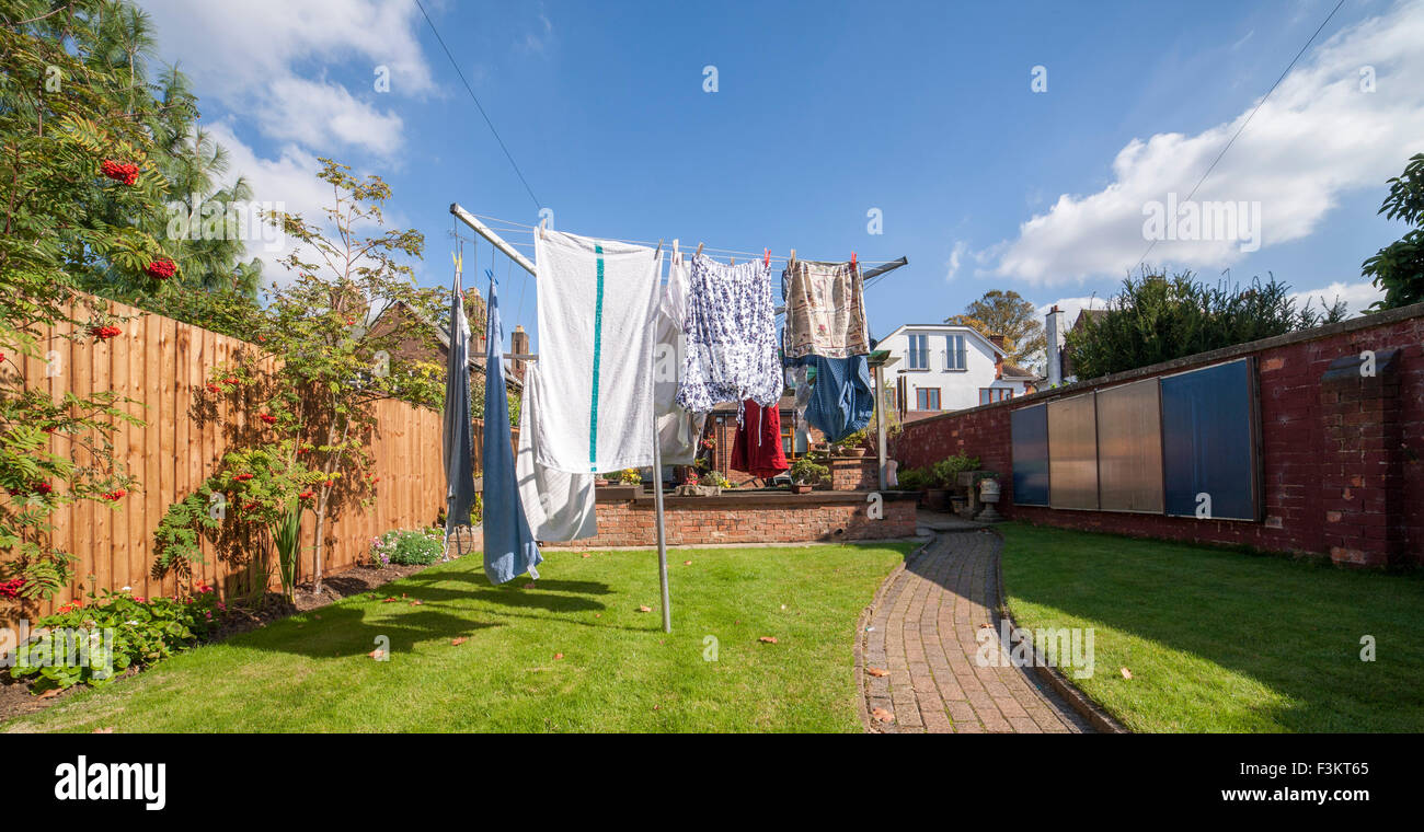Washing on a rotory cloths line in a back garden. Stock Photo
