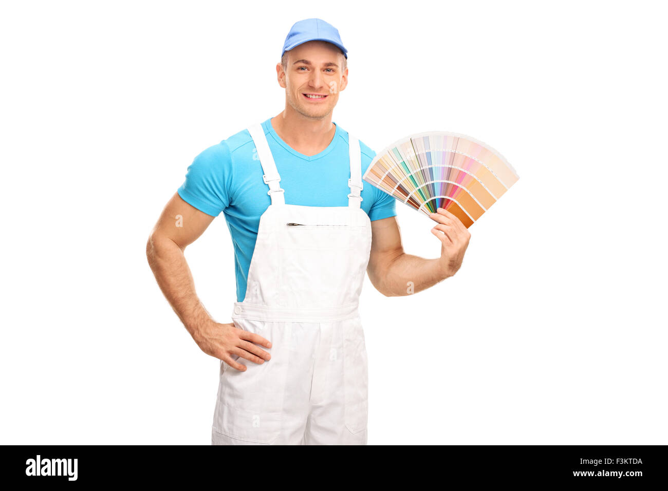 Young male decorator in white jumpsuit holding a color swatch and looking at the camera isolated on white background Stock Photo