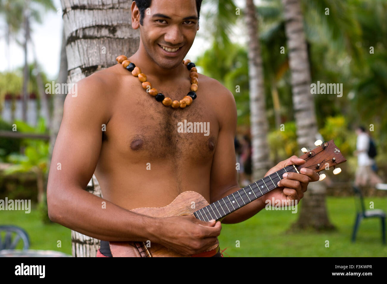 Man playing ukelele. Polynesian Cultural Center. O'ahu. Hawaii. The Polynesian Cultural Center (PCC) is a Polynesian-themed them Stock Photo