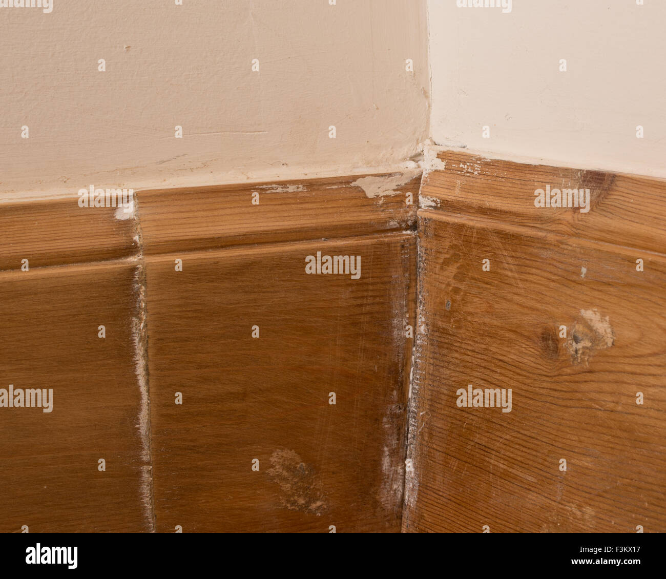 Poor diy workmanship - badly fitted wooden skirting boards with butted joints Stock Photo