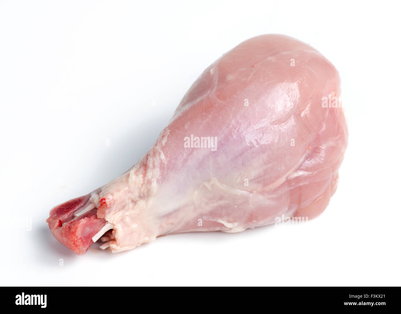 Fresh skinless chicken drumstick leg against white Stock Photo