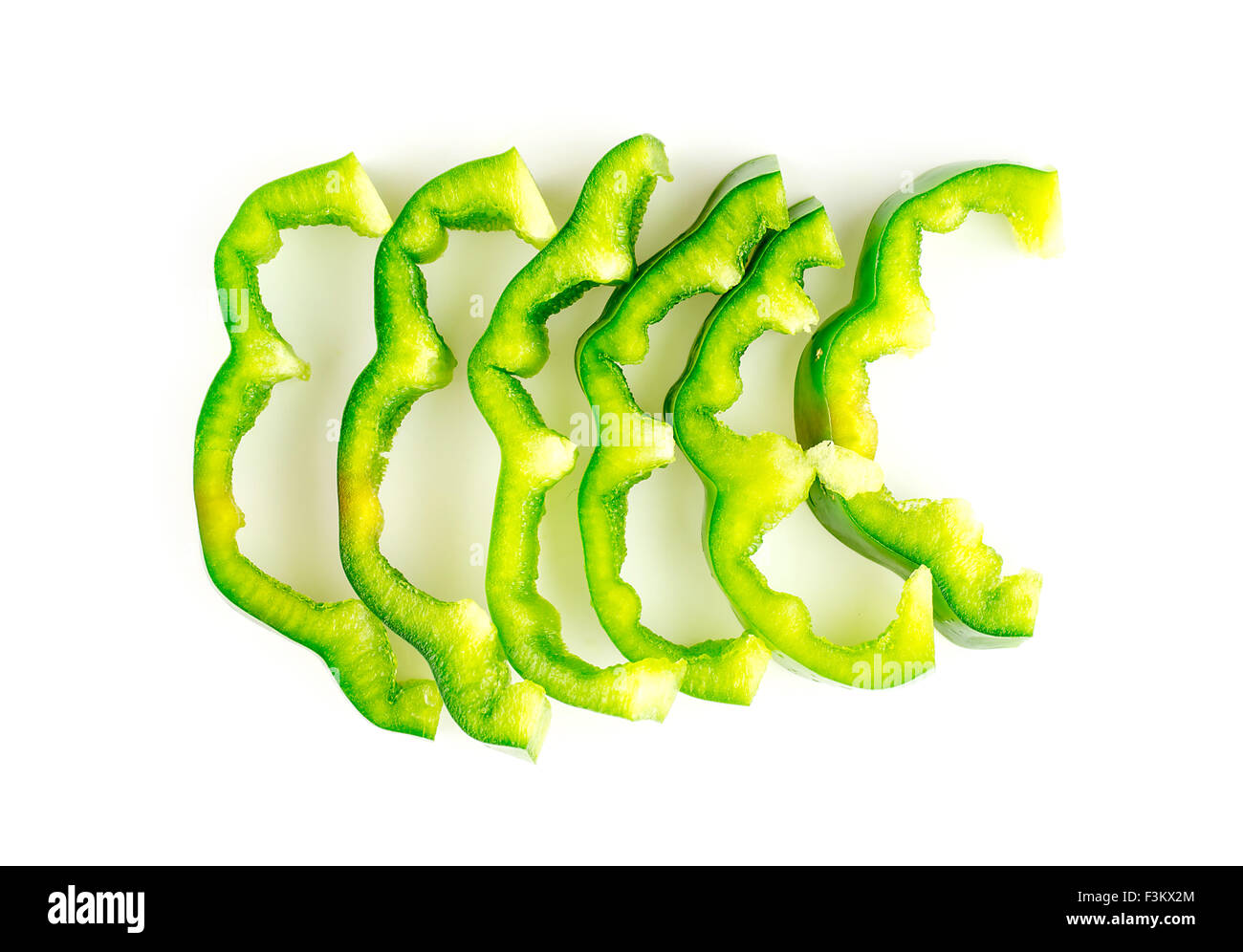 Aerial macro of vibrant green peppers cut up and sliced Stock Photo