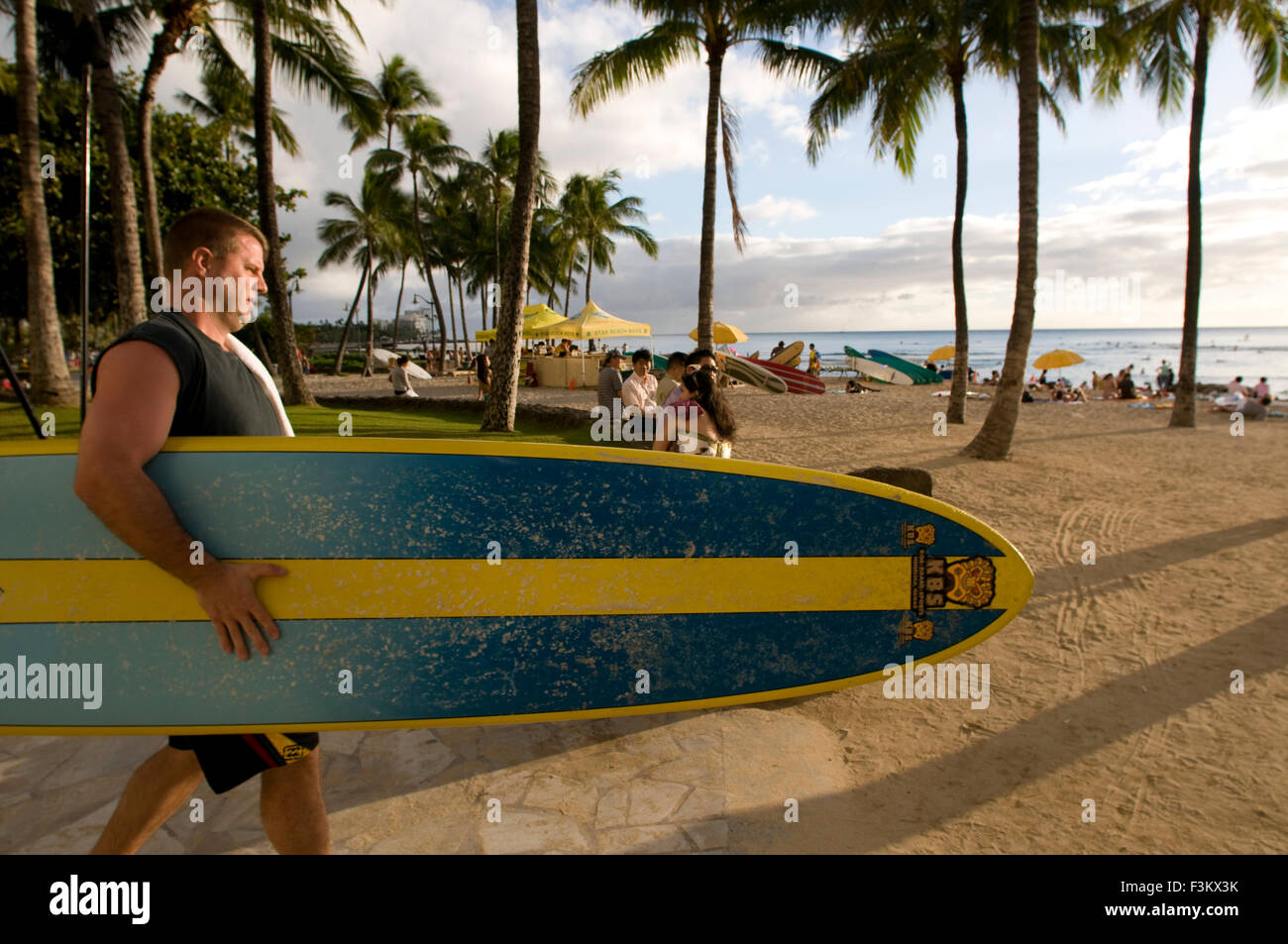 Surfer on the famous Waikiki Beach. Kalakaua Avenue. O'ahu. Hawaii. Located on the south shore of Honolulu, the world-famous nei Stock Photo
