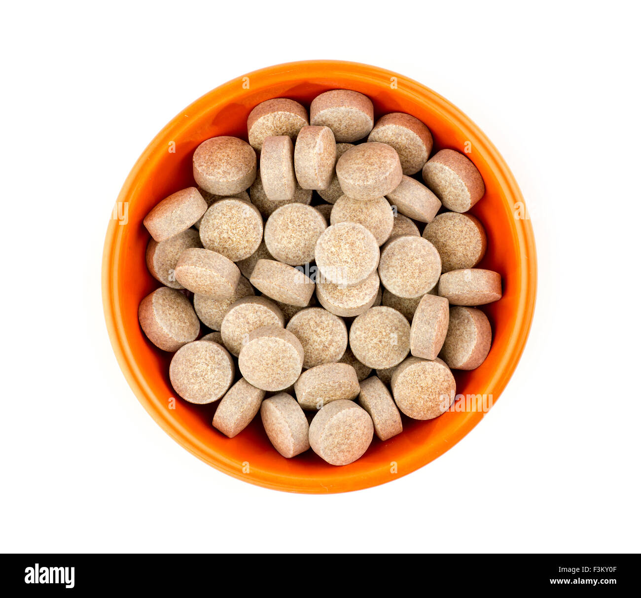 Orange herbal multi-vitamin pill tablets against white Stock Photo