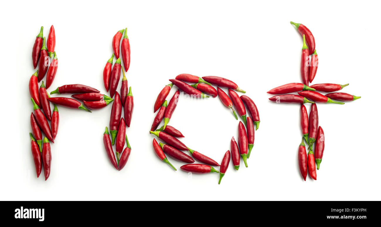 Home grown garden red chili peppers shaped in the word 'Hot' against a white background Stock Photo
