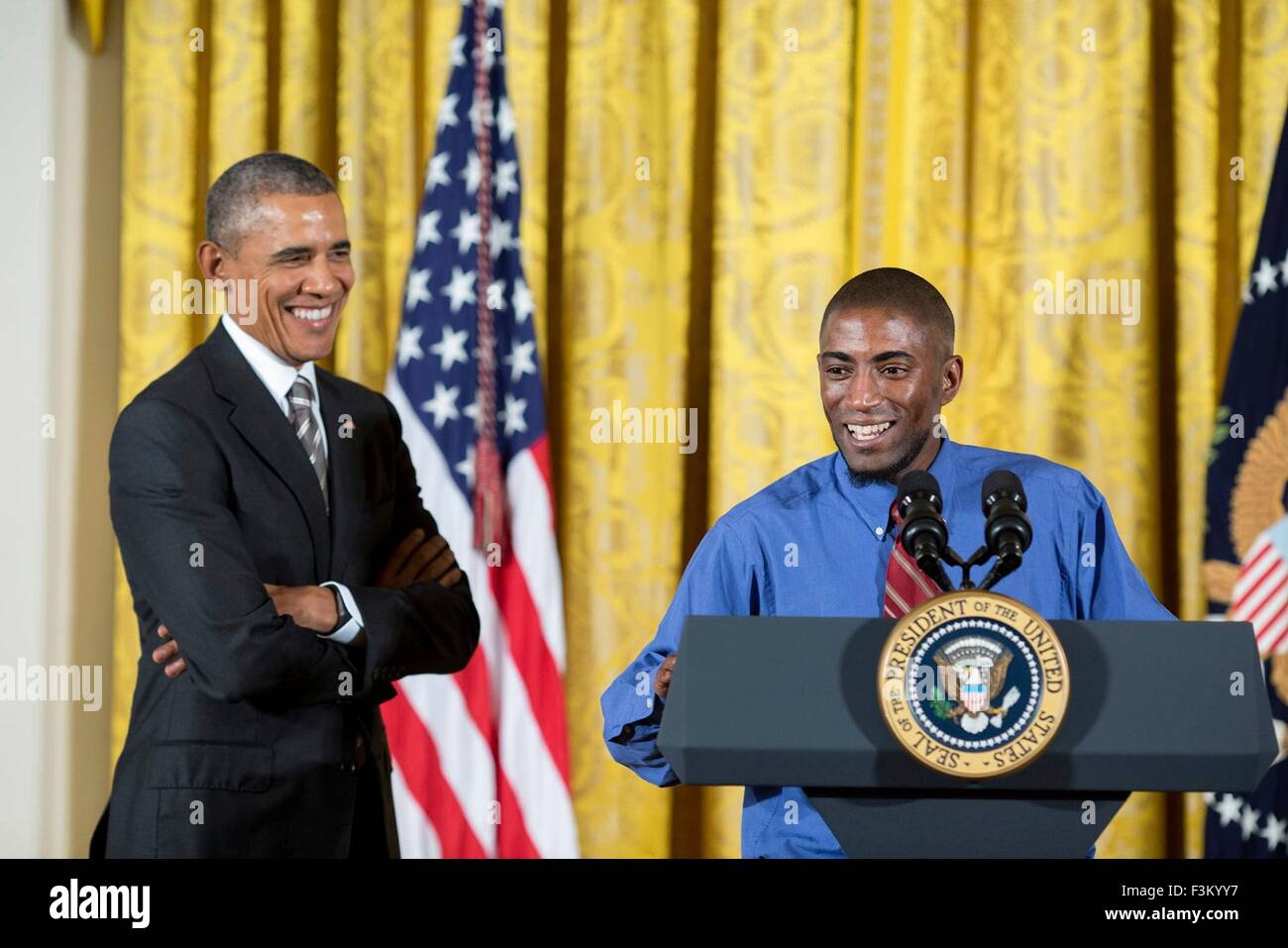 Washington DC, USA. 7th October, 2015. U.S. President Barack Obama smiles as Terrence Wise of Fight for $15 introduces him at the White House Summit on Worker Voice in the East Room October 7, 2015 in Washington, DC. Terrence Wise is a second-generation minimum wage fast-food worker. Stock Photo
