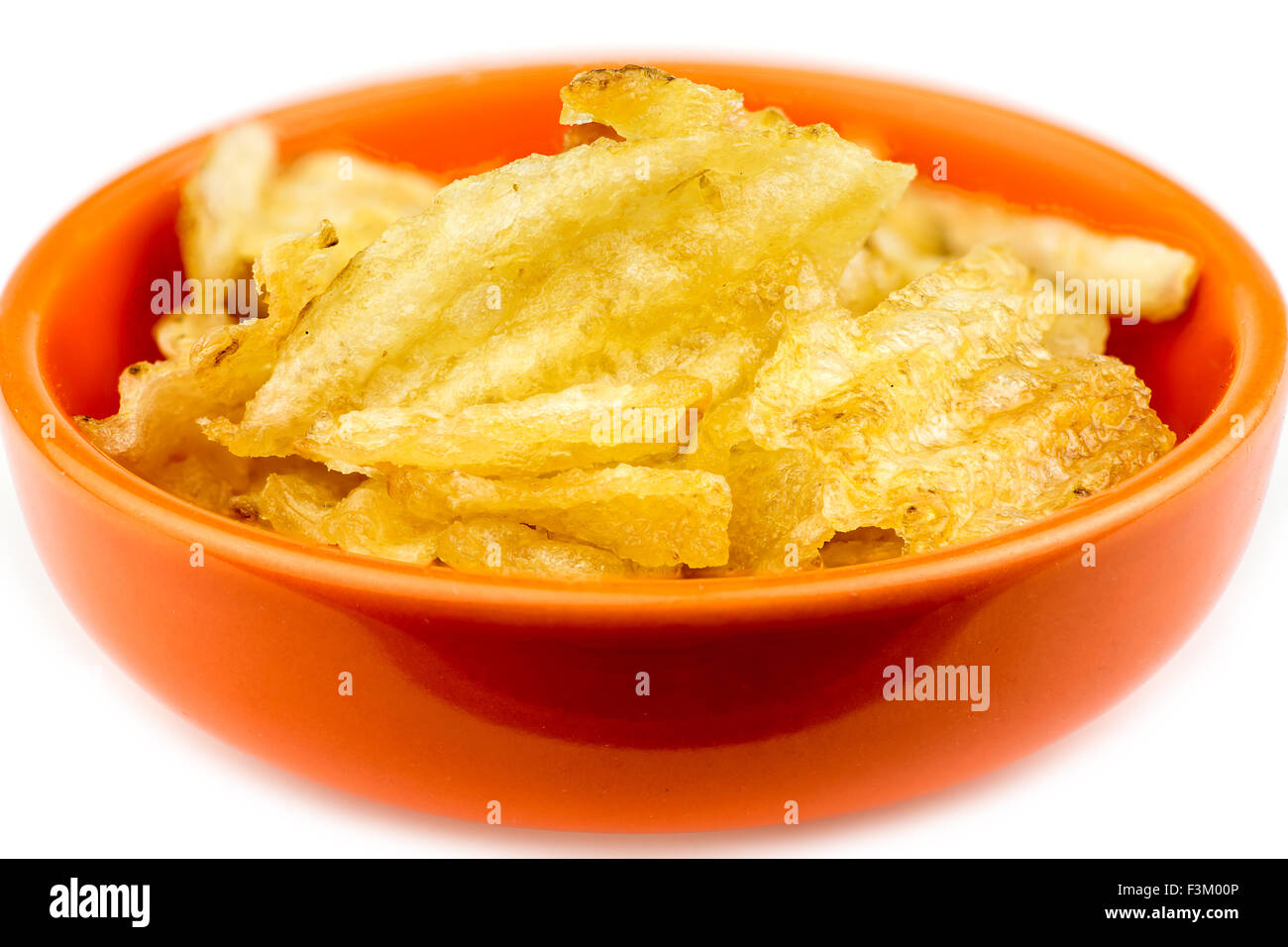Thick rippled potato chips in bowl isolated Stock Photo