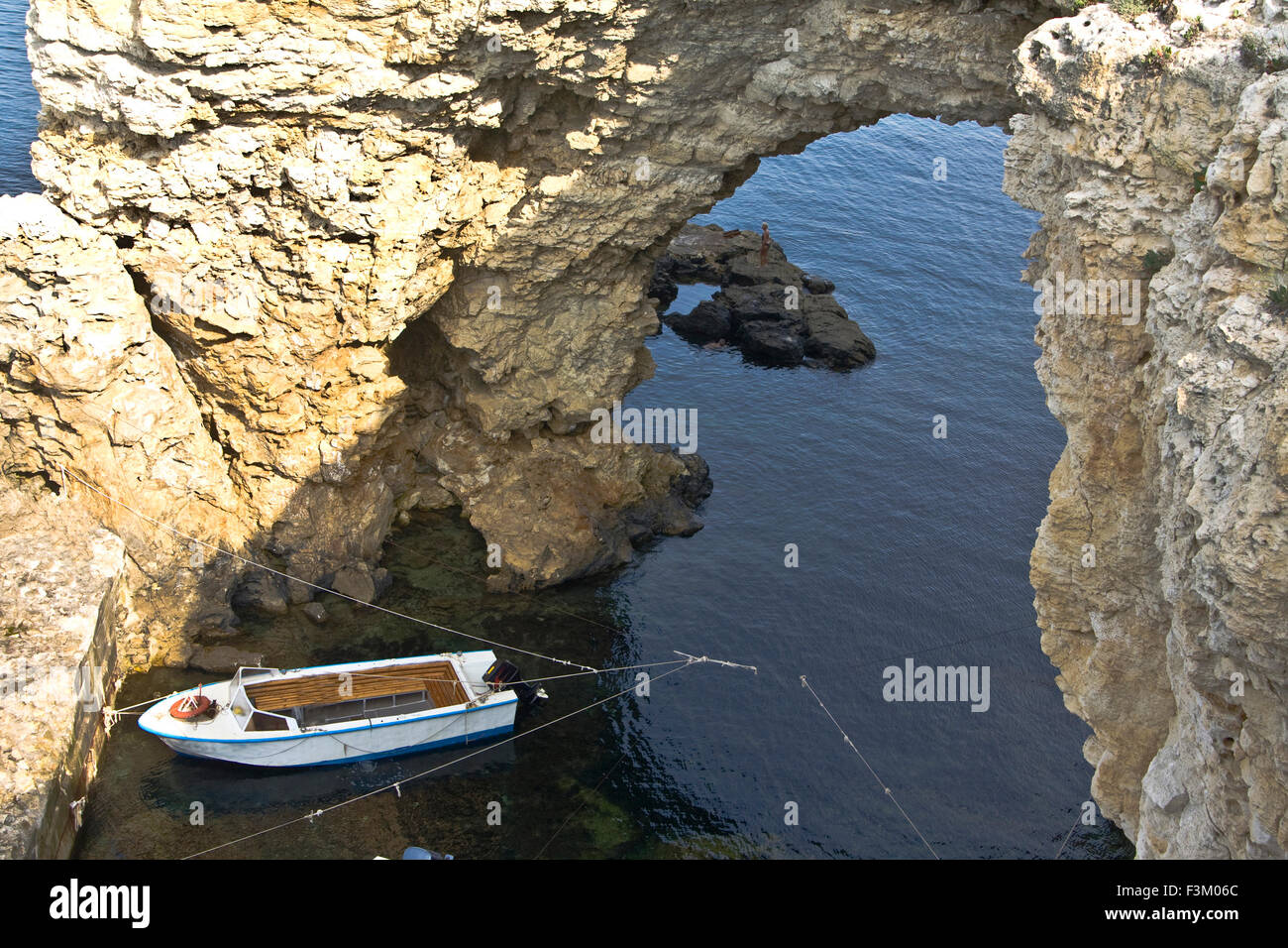 Sea landscape with rock and boat, recorded in place Tarhankut in region Crimea on Black sea. Stock Photo
