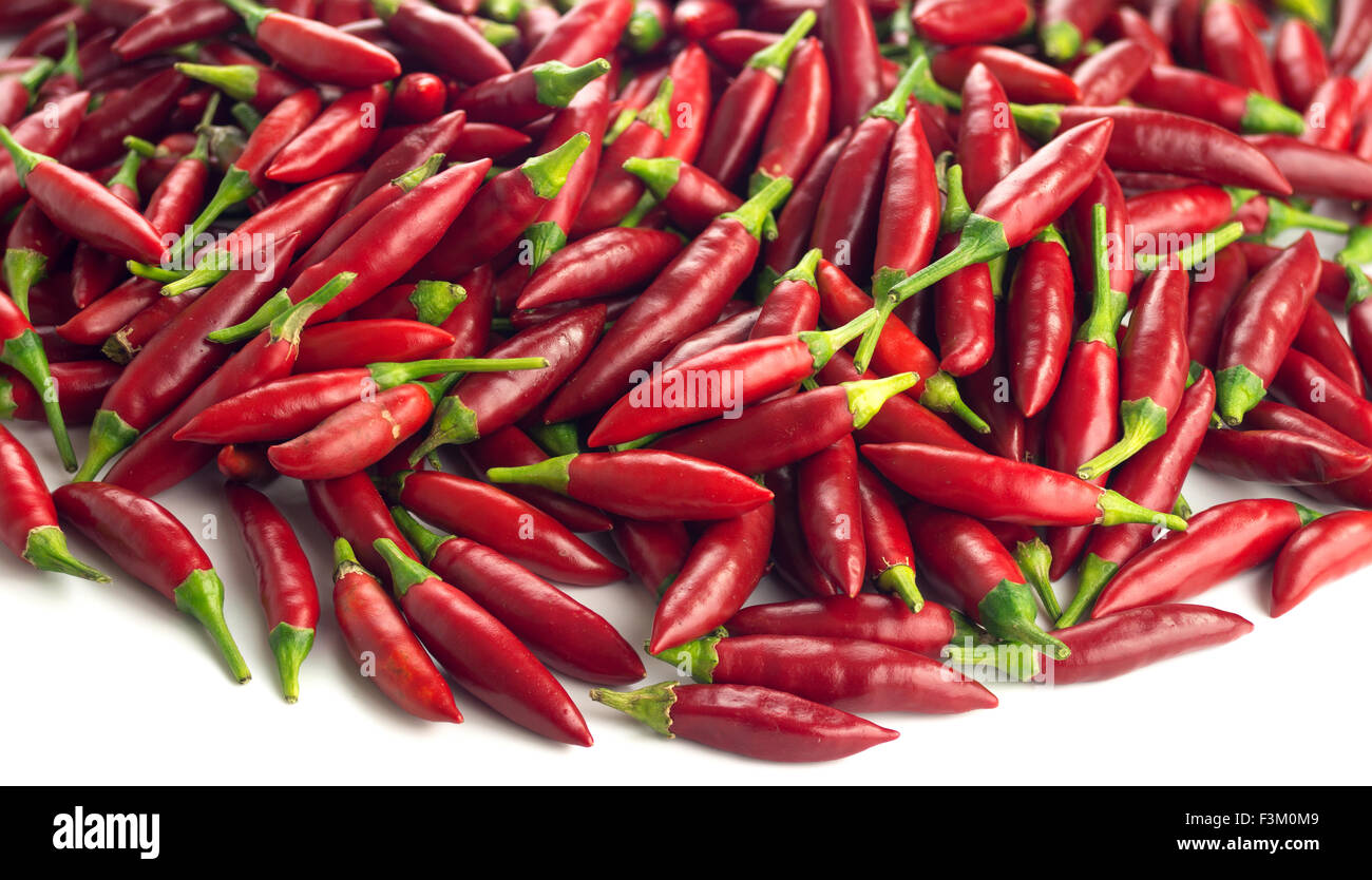 Pile of ripe red chili peppers against a white background Stock Photo