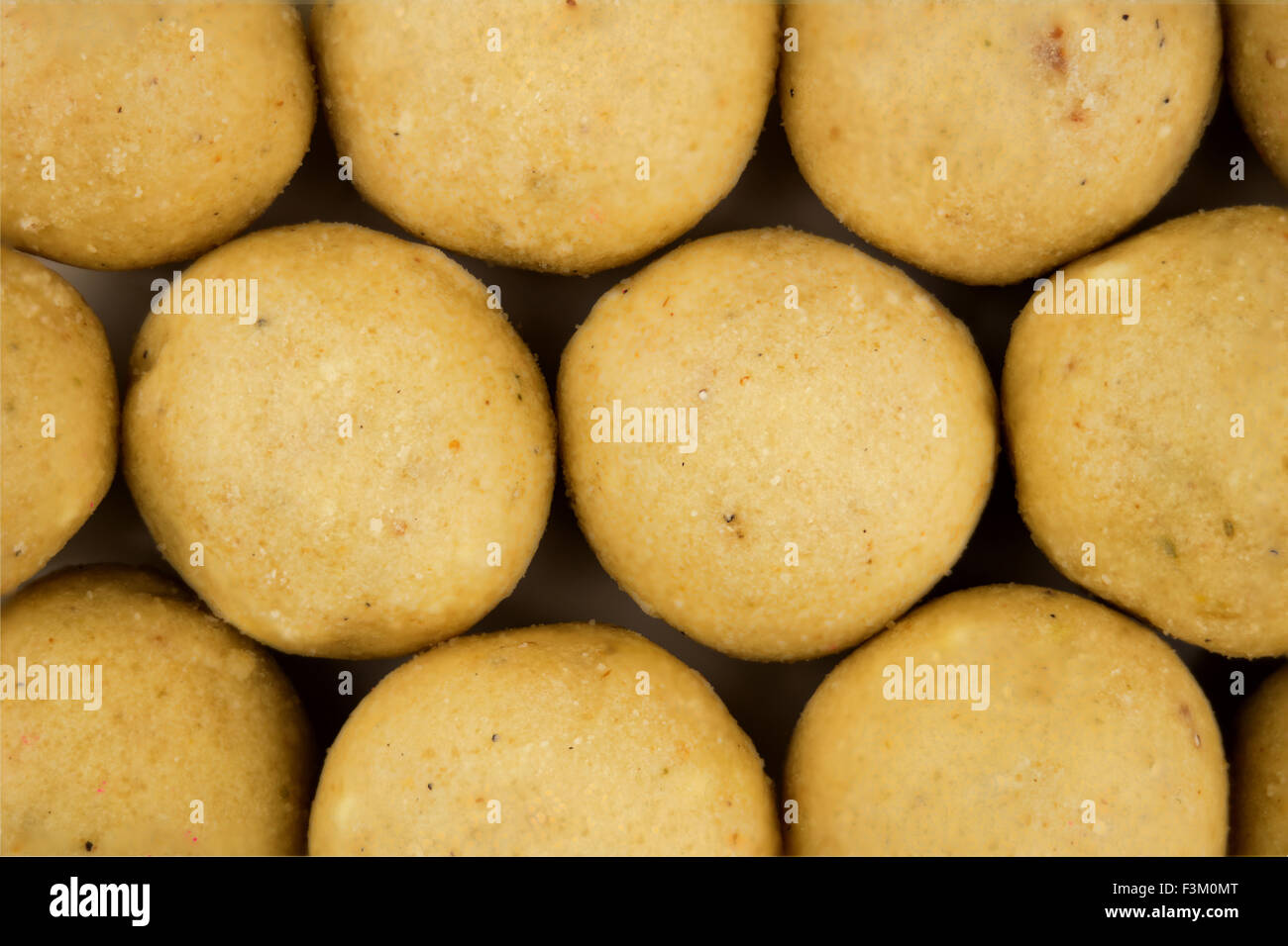 Close up macro shot of Indian truffle balls called laddu (laddoo). Stock Photo