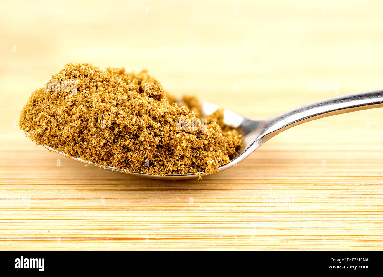 Macro closeup of crushed cumin seeds in spoonful Stock Photo