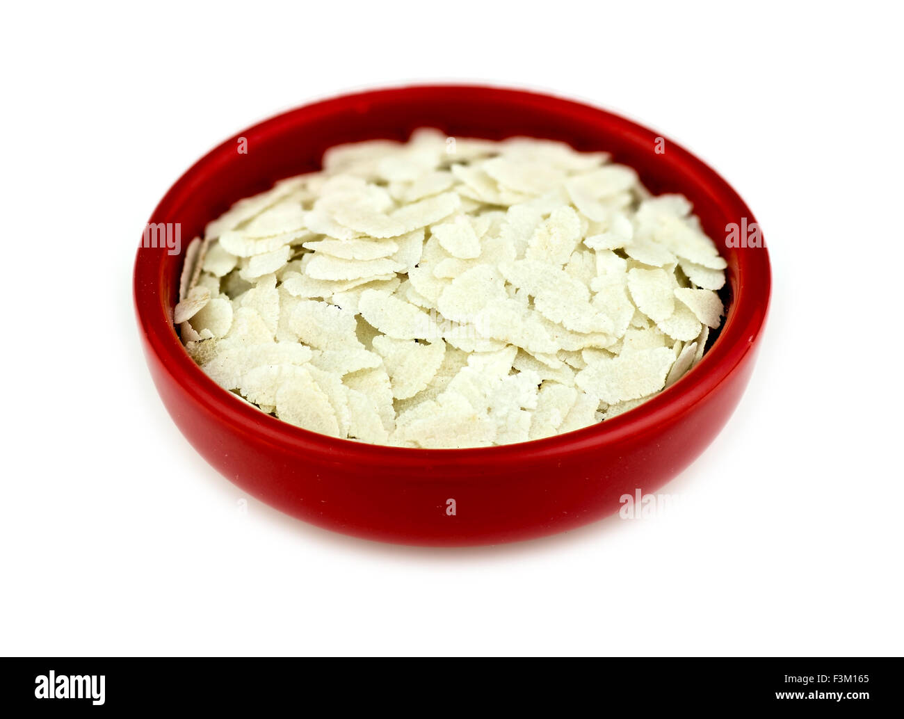 Bowl of uncooked puffed rice poha isolated Stock Photo