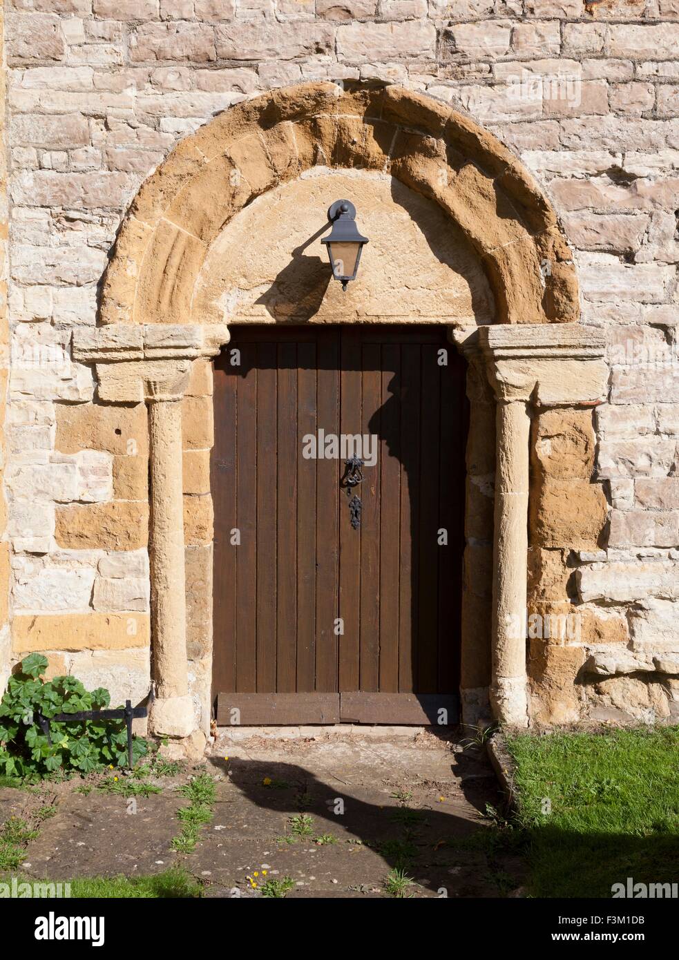 Norman doorway in Cotswold church wall, England. Stock Photo
