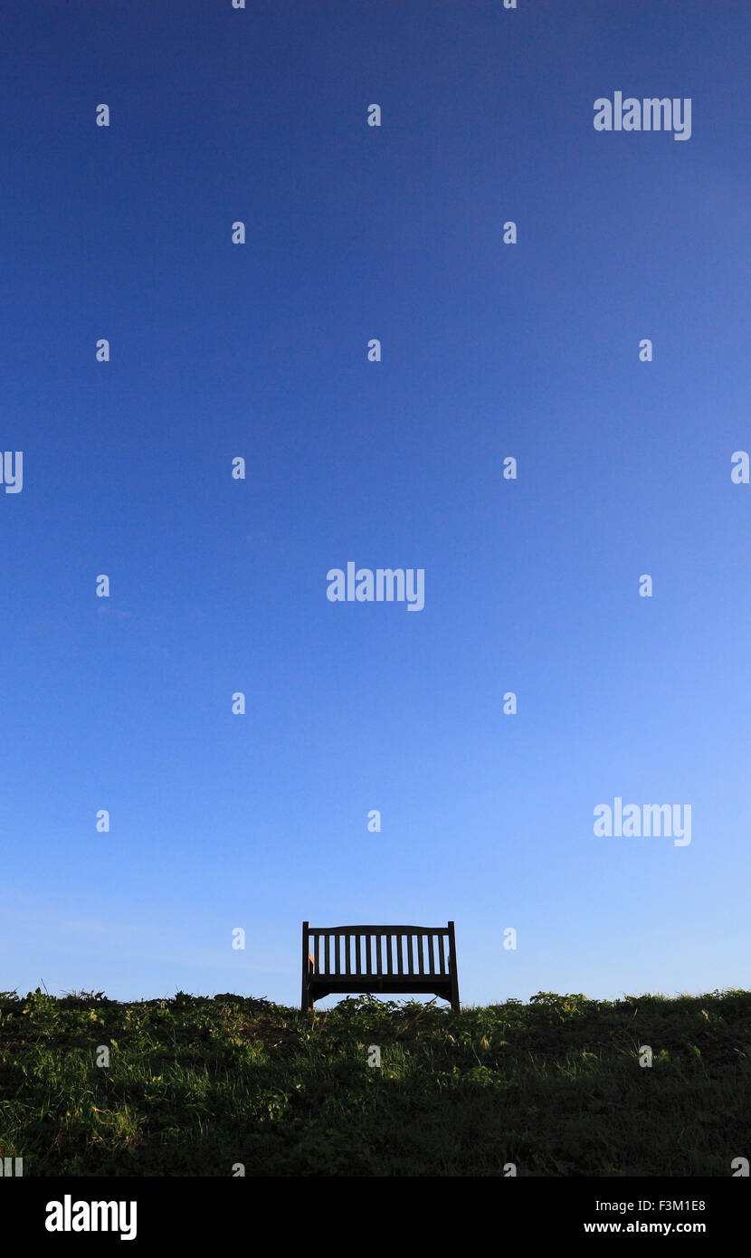 A wooden bench and a big blue clear sky. Stock Photo