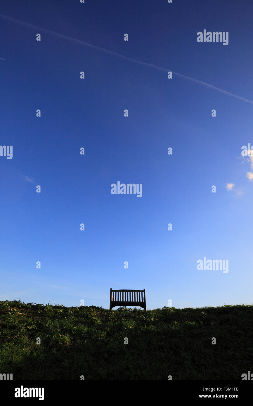 A wooden bench and a big blue clear sky. Stock Photo