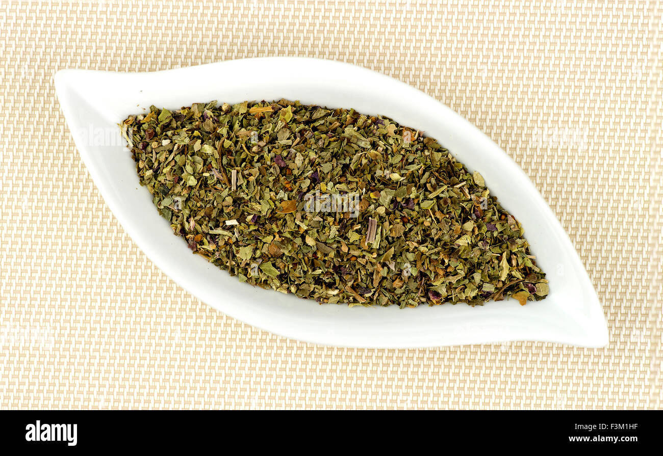 Dehydrated and dried basil leaves chopped in gourmet dish Stock Photo