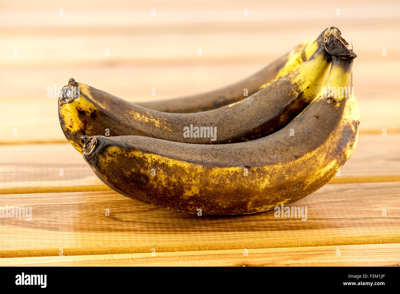 Rotten old bananas on wooden background Stock Photo Alamy