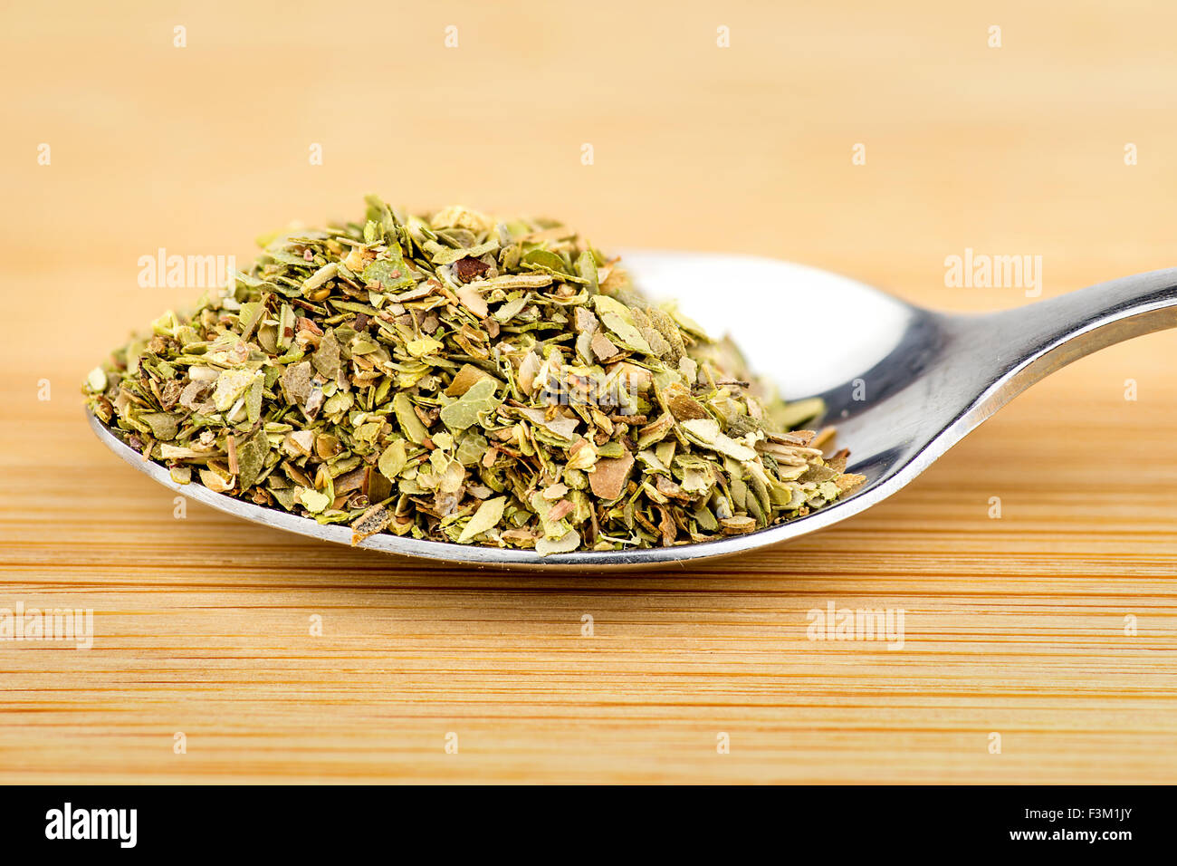 Teaspoon of freshly dried basil herb Stock Photo