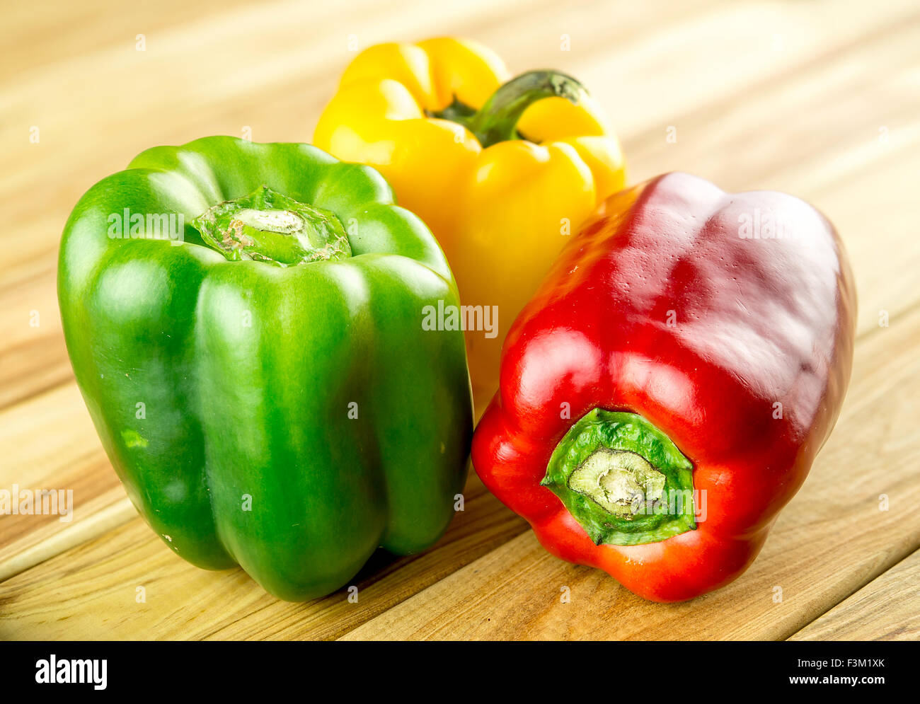Variety of bell peppers on chopping board Stock Photo - Alamy