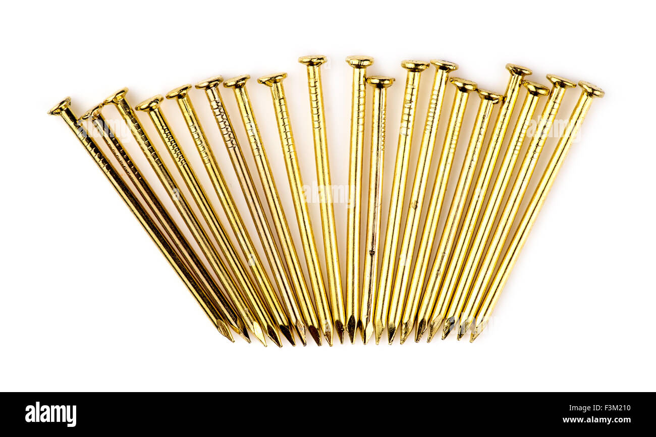 Row of new golden brass nails isolated on white Stock Photo