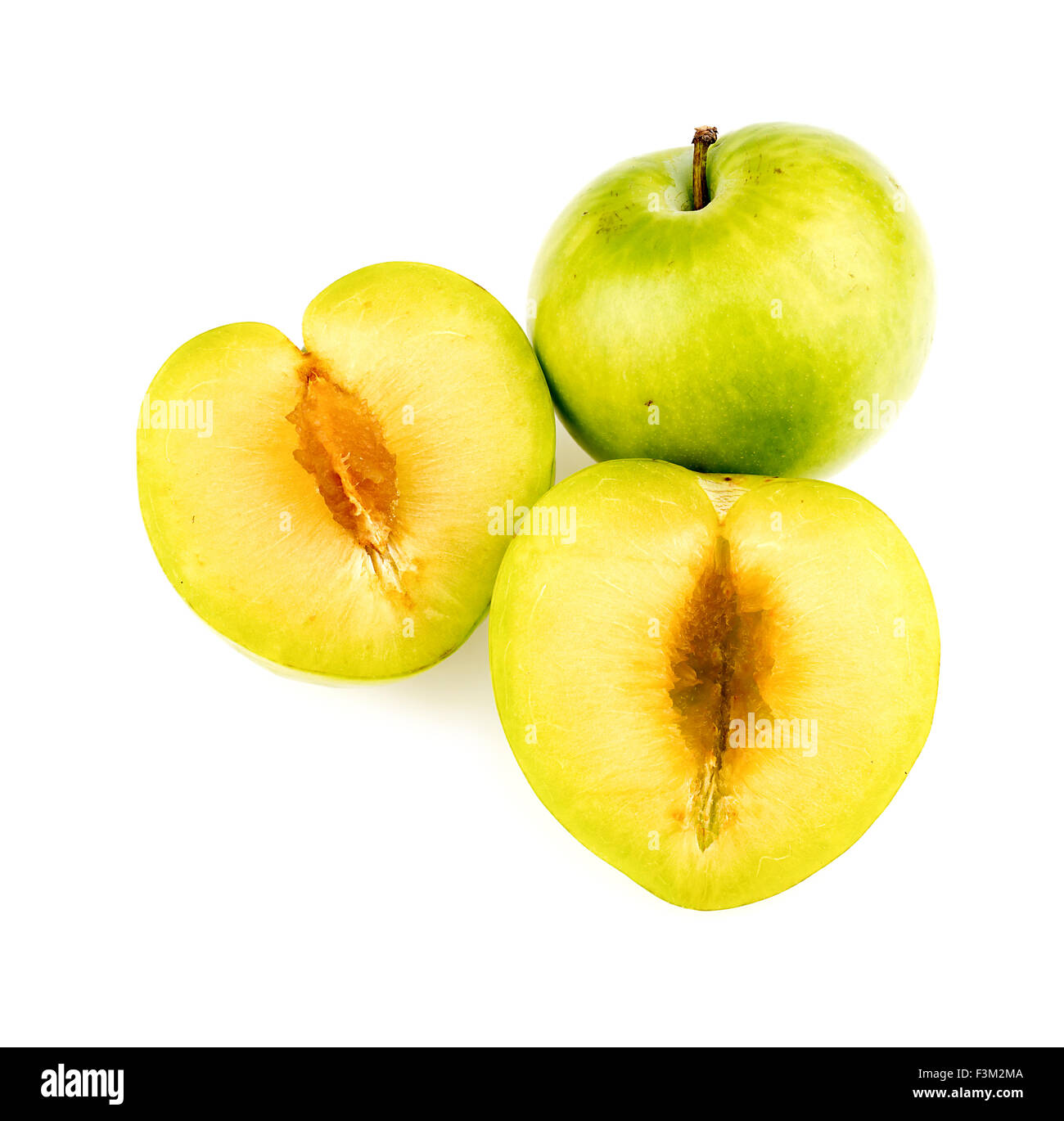 Green plum chopped in half isolated studio Stock Photo Alamy
