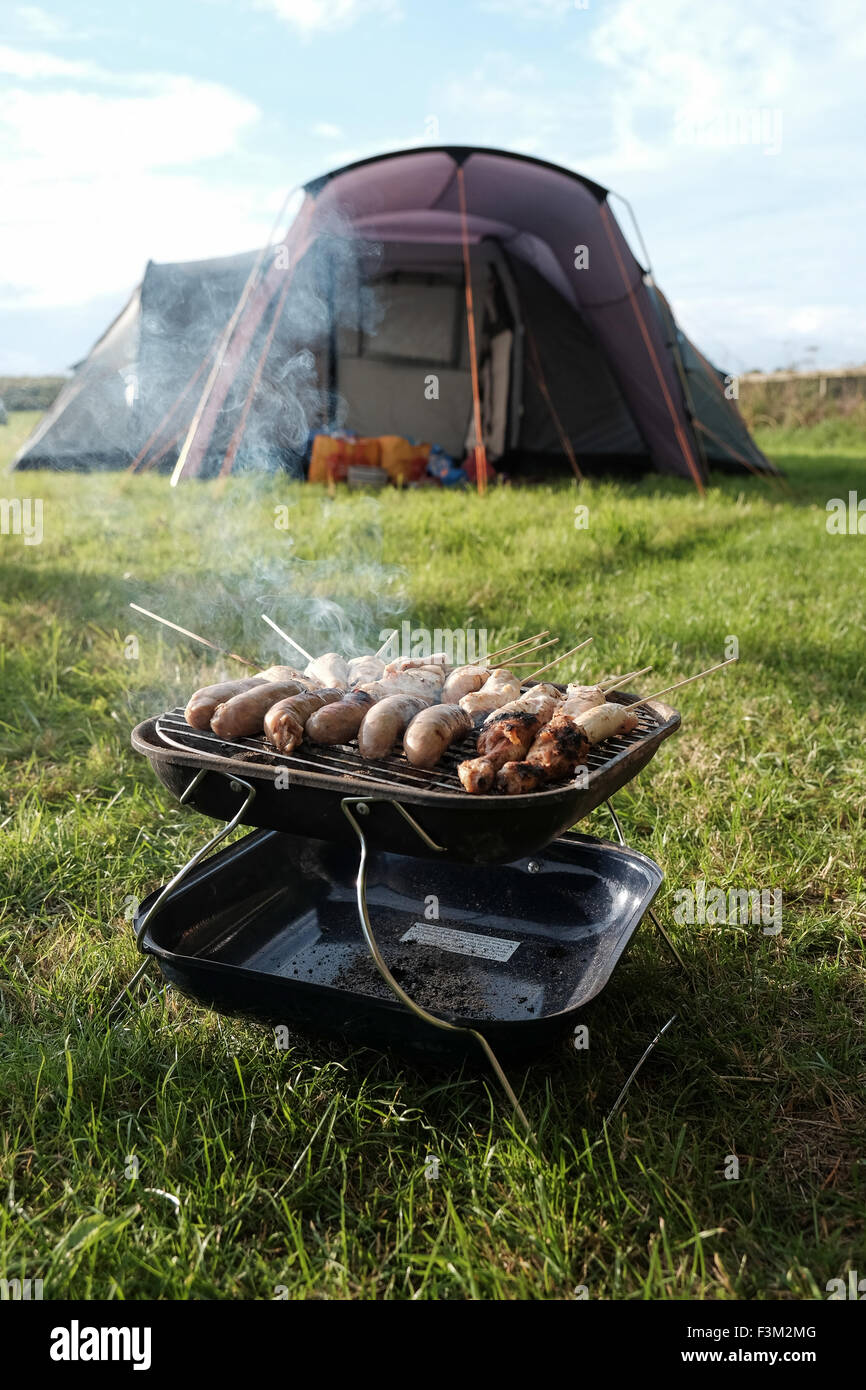 Barbecue outside a tent with food cooking Stock Photo Alamy