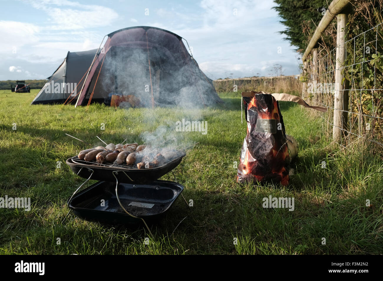 Barbecue next to a tent Stock Photo