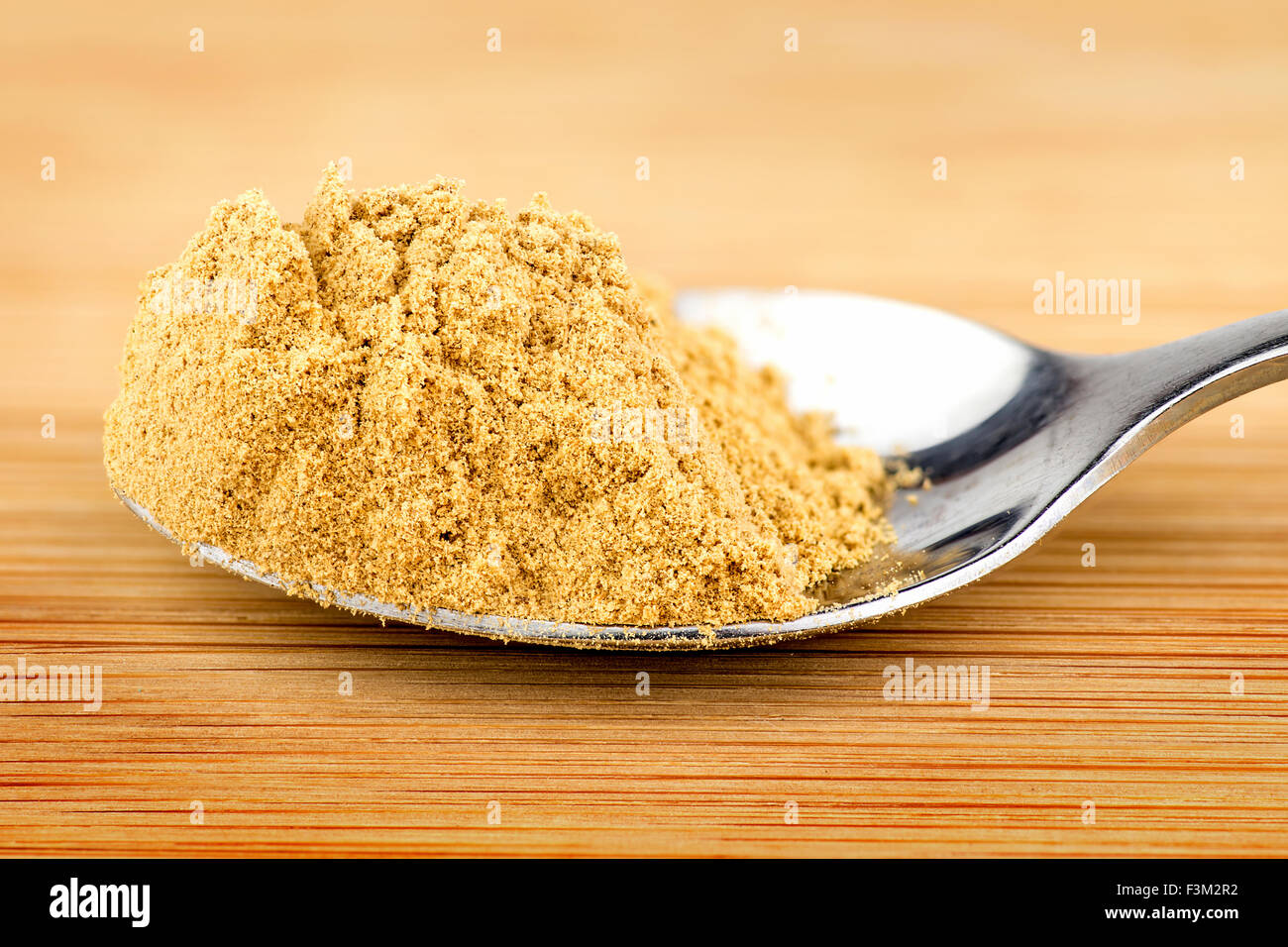 Spoonful of ground ginger powder Stock Photo