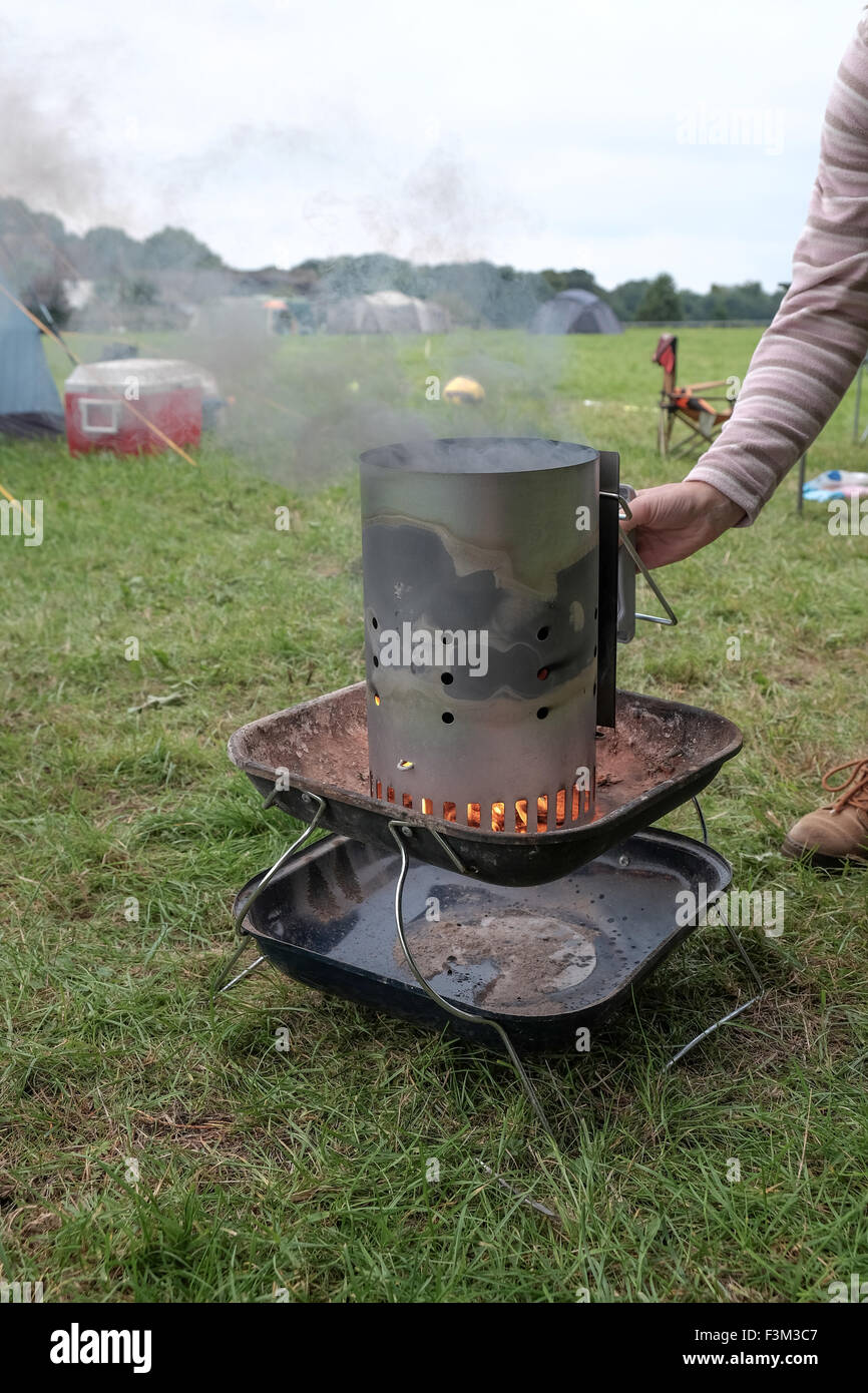 Chimney barbecue starter in use whilst camping Stock Photo Alamy
