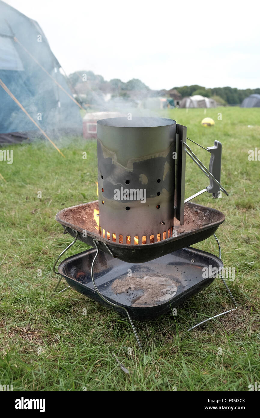 Chimney barbecue starter in use whilst camping Stock Photo Alamy