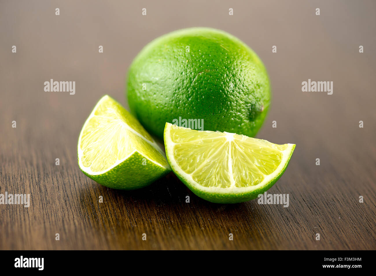 Vibrant limes on bar counter for shots Stock Photo